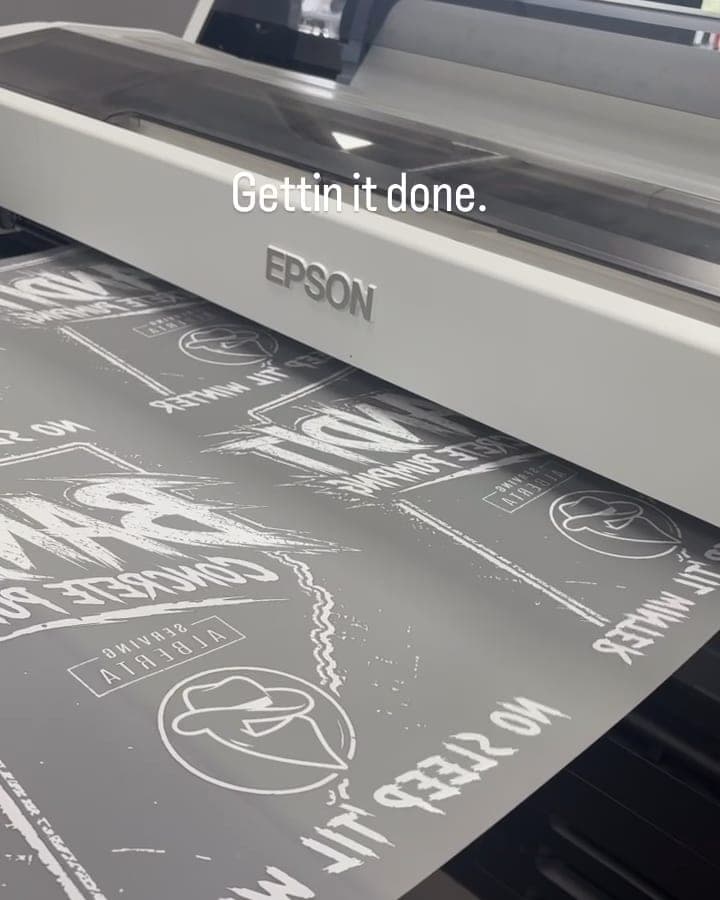 DTF printer printing white-ink transfers in the Lygas Co shop