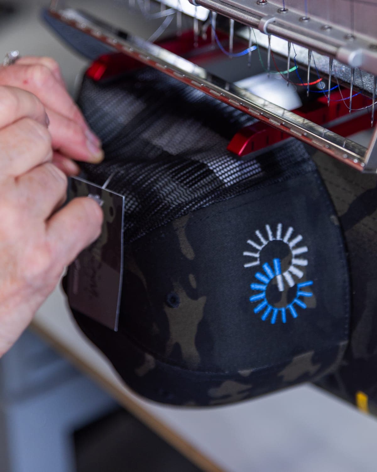 Snapback cap clamped in the embroidery machine