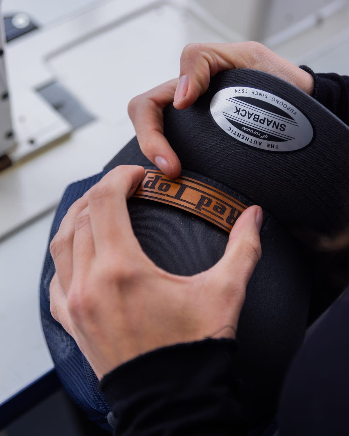 Holding a leather patch in place on a black snapback