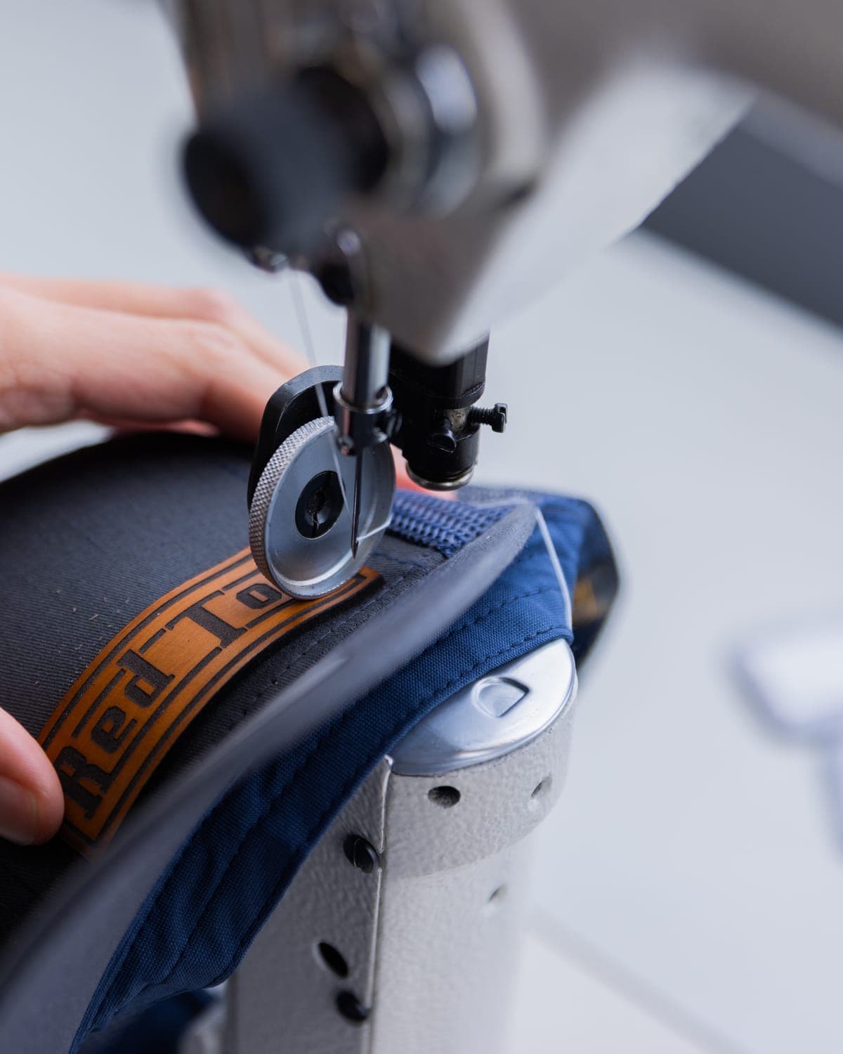 Stitching a leather patch onto a cap