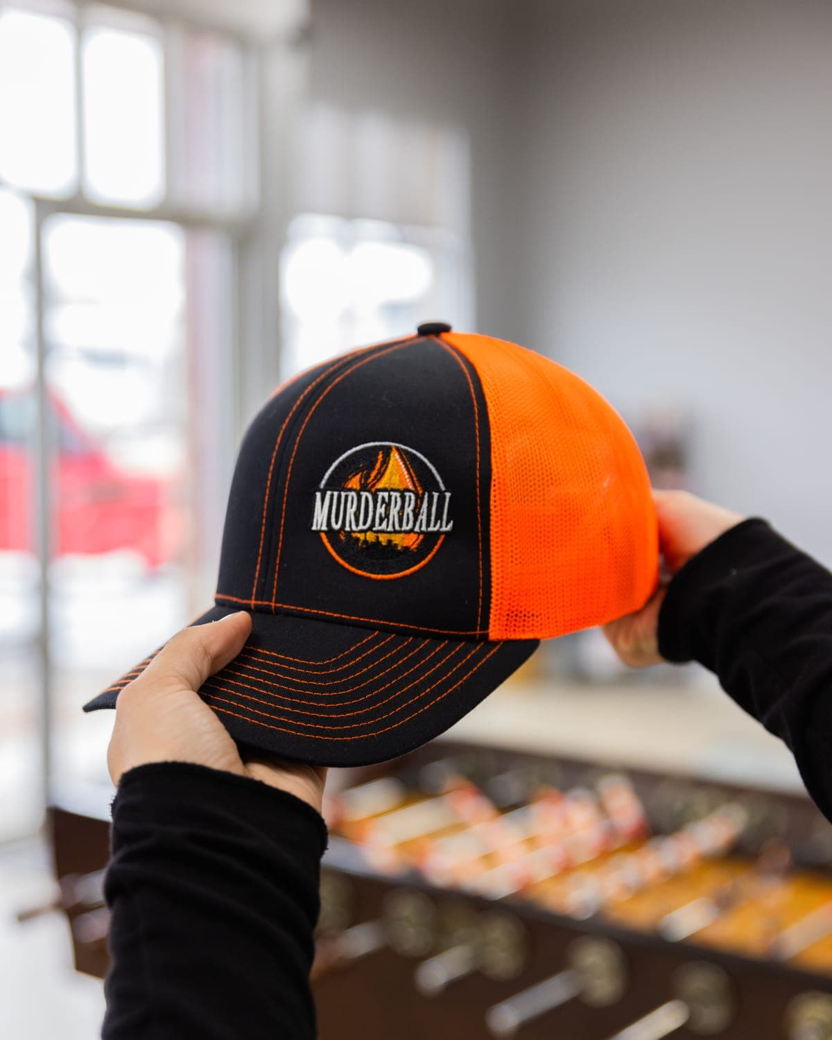 Black and orange Murderball trucker cap