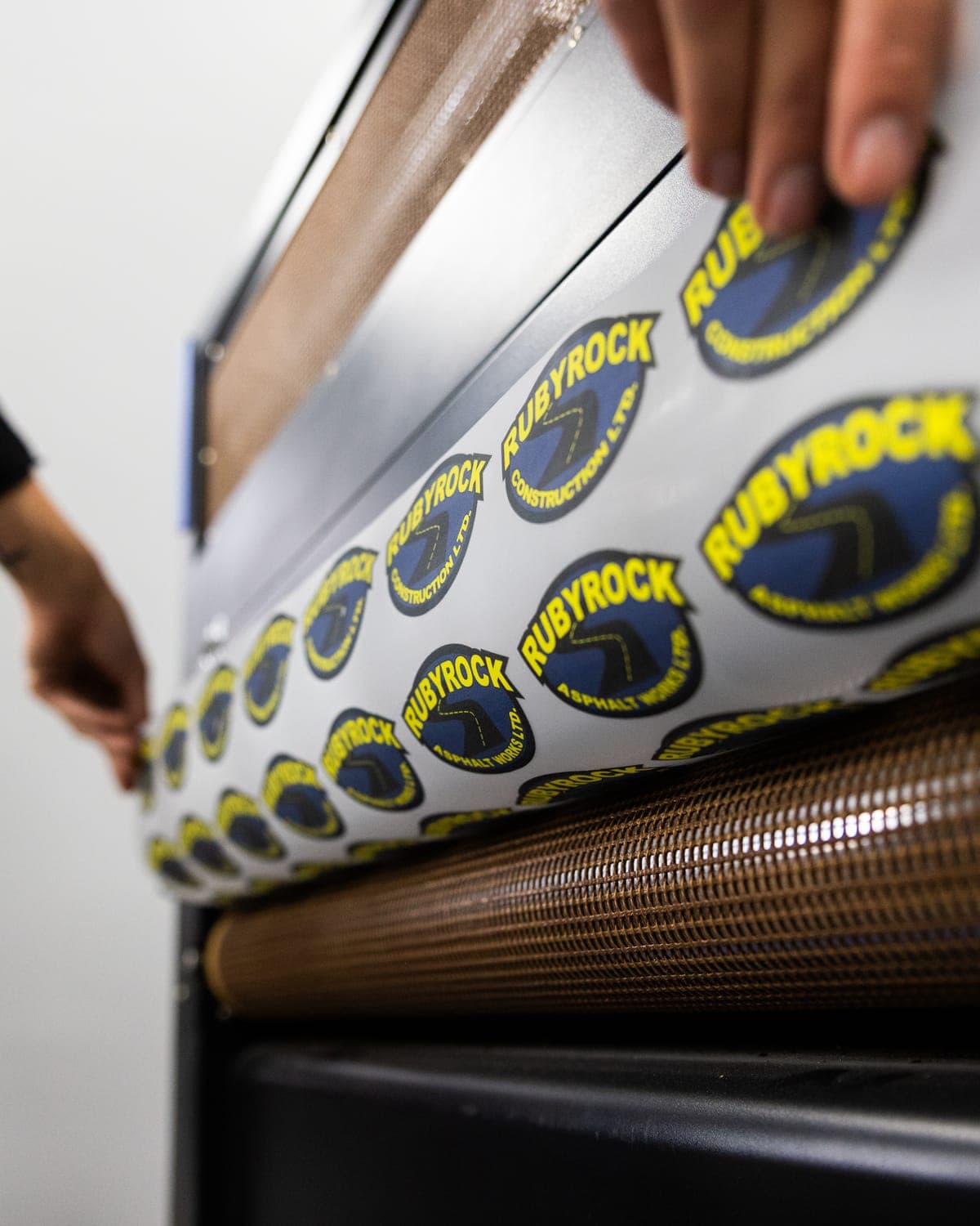 A sheet of Rubyrock DTF transfers coming out of the curing tunnel