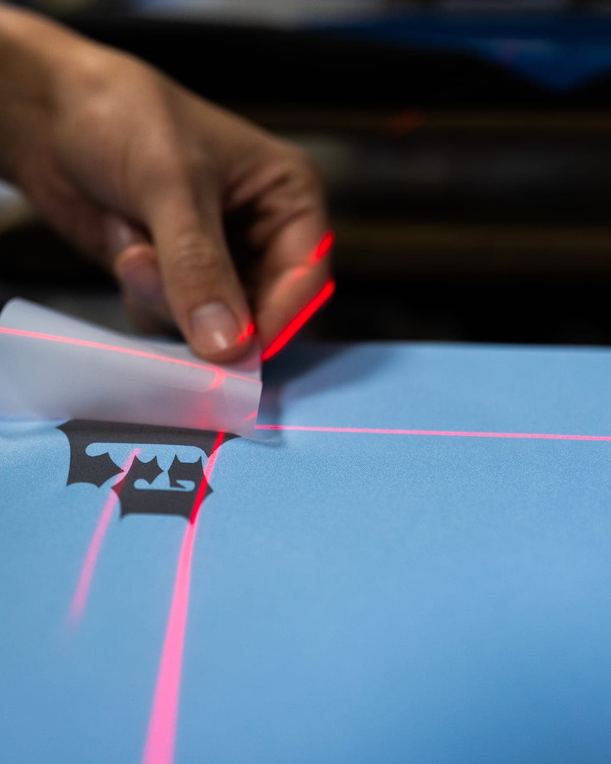 Peeling the film off a fresh DTF transfer