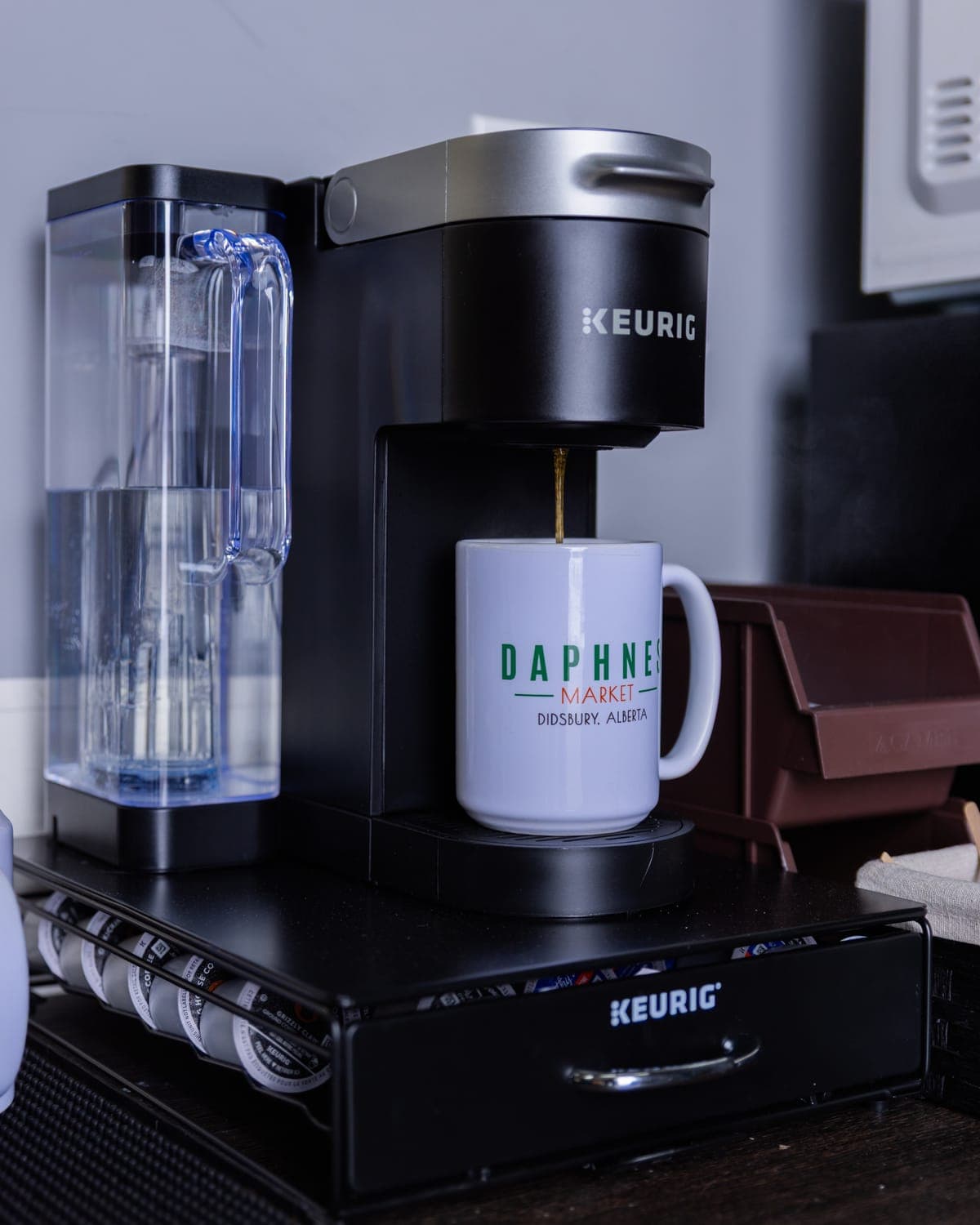 White Daphne's Market mug under a coffee maker