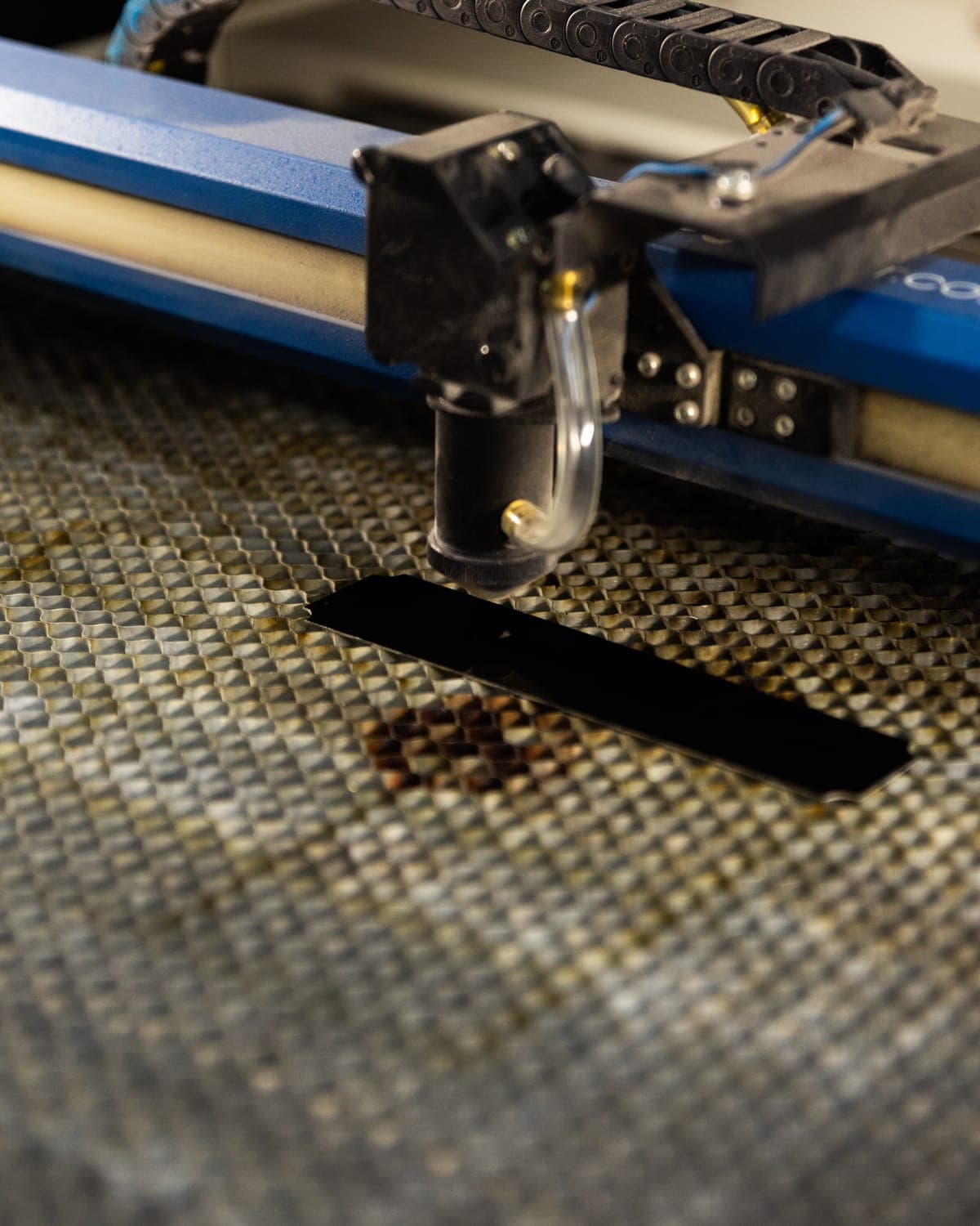 Laser engraver cutting a name badge